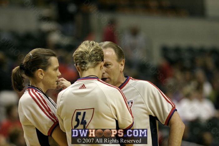 Sue Blauch, Laura Morris, and Bob Trammell huddle to discuss what ended up being a jump ball